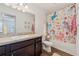 Charming bathroom boasts dark wood cabinets and a colorful unicorn-themed shower curtain at 955 Grandin St, Davenport, FL 33837