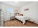 Bright bedroom with carpet features a twin bed, side table, and chest of drawers at 955 Grandin St, Davenport, FL 33837