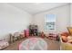 Bright bedroom with carpet featuring a small desk, shelving, and a fluffy round rug at 955 Grandin St, Davenport, FL 33837