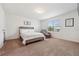 Bright bedroom with a comfortable bed, chair, and plenty of natural light at 955 Grandin St, Davenport, FL 33837