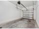 A single car garage with a clean, bare concrete floor and a functional overhead door system ready for use at 955 Grandin St, Davenport, FL 33837