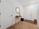 Hallway with carpet, doors, table, and mirrors at 955 Grandin St, Davenport, FL 33837