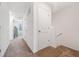 Second floor hallway with carpet and white walls at 955 Grandin St, Davenport, FL 33837