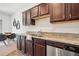 Modern kitchen features stainless steel appliances and granite countertops at 955 Grandin St, Davenport, FL 33837