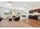 Cozy living room featuring plush carpet, a leather sofa, and a dining area with lots of natural light at 955 Grandin St, Davenport, FL 33837