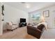 Bright living room with plush carpeting, a comfortable sofa, and ample natural light at 955 Grandin St, Davenport, FL 33837