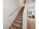 Carpeted staircase leading to the second floor, with a view of the living area at 955 Grandin St, Davenport, FL 33837
