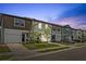 Charming townhomes with colorful facades and well-manicured landscaping on a peaceful street at 955 Grandin St, Davenport, FL 33837