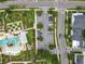 An aerial view showcases the community pool, parking, and manicured landscaping near a picturesque neighborhood at 960 Civitas Way, Winter Garden, FL 34787