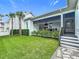 View of the fenced backyard featuring a covered patio with an outdoor kitchen and a seating area at 960 Civitas Way, Winter Garden, FL 34787