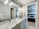 Bright bathroom features a double sink vanity with marble countertop and modern lighting fixtures at 960 Civitas Way, Winter Garden, FL 34787