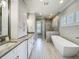 Luxurious bathroom with soaking tub, walk-in shower, and elegant fixtures at 960 Civitas Way, Winter Garden, FL 34787