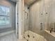 Modern glass shower with pebble floor and large grey tiles at 960 Civitas Way, Winter Garden, FL 34787