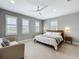 Bright bedroom featuring a wooden bed frame, ceiling fan, and three shuttered windows allowing natural light at 960 Civitas Way, Winter Garden, FL 34787