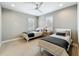 Neutral bedroom featuring two twin beds, a ceiling fan, and bright windows at 960 Civitas Way, Winter Garden, FL 34787