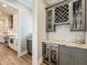 Charming butler's pantry featuring wine rack, wine fridge, and entry to kitchen at 960 Civitas Way, Winter Garden, FL 34787