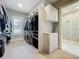 Walk-in closet with custom shelving and drawers next to ensuite bathroom at 960 Civitas Way, Winter Garden, FL 34787