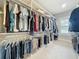 Walk-in closet with custom shelving and hanging rods for ample storage at 960 Civitas Way, Winter Garden, FL 34787