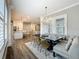 Open-concept living space connects the dining area with stylish seating to the kitchen at 960 Civitas Way, Winter Garden, FL 34787
