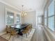 Elegant dining room with large windows offering ample natural light and comfortable seating at 960 Civitas Way, Winter Garden, FL 34787