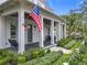 Inviting front porch with an American flag, comfortable seating, and lush landscaping creating a welcoming entrance at 960 Civitas Way, Winter Garden, FL 34787