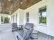 Inviting front porch with comfortable seating and a ceiling fan creating a relaxing atmosphere at 960 Civitas Way, Winter Garden, FL 34787