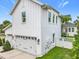 This is a view of the side of the home with a two-car garage and white exterior at 960 Civitas Way, Winter Garden, FL 34787