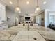 Kitchen island sink view into the open floor plan with a living room and fireplace at 960 Civitas Way, Winter Garden, FL 34787