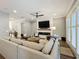 Bright living room with a modern fireplace, a ceiling fan, and stylish shuttered doors at 960 Civitas Way, Winter Garden, FL 34787