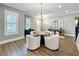 Bright living room with hardwood floors, chandelier, and neutral paint offers flexible living space at 960 Civitas Way, Winter Garden, FL 34787
