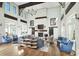 An inviting living room with high ceilings, brick fireplace, and stylish furnishings, perfect for entertaining at 960 Civitas Way, Winter Garden, FL 34787