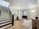 Open-concept living room with staircase, natural light, and hardwood floors for easy living and entertaining at 960 Civitas Way, Winter Garden, FL 34787