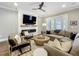 Living room with modern fireplace, TV, hardwood floors, and comfortable sectional seating at 960 Civitas Way, Winter Garden, FL 34787