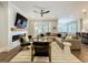 Stylish living room with modern fireplace, TV, neutral paint, and comfortable seating at 960 Civitas Way, Winter Garden, FL 34787
