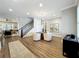 Bright living room with hardwood floors, a round table and chairs, and a staircase to the second level at 960 Civitas Way, Winter Garden, FL 34787