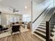 Open concept living room with hardwood floors, fan, and stairs offers a modern aesthetic at 960 Civitas Way, Winter Garden, FL 34787