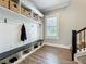 Mudroom with built-in bench, storage cubbies, and hooks, perfect for organization at 960 Civitas Way, Winter Garden, FL 34787