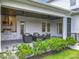 This covered outdoor patio features an outdoor kitchen, a seating area, and views of the beautiful backyard at 960 Civitas Way, Winter Garden, FL 34787