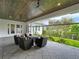 This covered outdoor patio area has a wood ceiling, ceiling fans, tile floor, and a comfortable seating area at 960 Civitas Way, Winter Garden, FL 34787