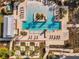 An aerial view of a luxury pool area with sun loungers, palm trees, and pristine landscaping at 960 Civitas Way, Winter Garden, FL 34787
