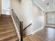 Hardwood staircase featuring craftsman style wood and iron banister and bright windows at 960 Civitas Way, Winter Garden, FL 34787