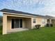 Backyard view with sliding glass door, grassy lawn, and air conditioning unit at 9721 Old Patina Way, Orlando, FL 32832