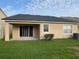 Backyard view with sliding glass door, grassy lawn, and air conditioning unit at 9721 Old Patina Way, Orlando, FL 32832