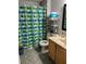 The bathroom features a shower with blue and green curtains, toilet, and a stainless steal rack at 9721 Old Patina Way, Orlando, FL 32832