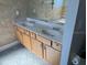Bathroom vanity with double sinks and a large mirror, offering ample space for grooming and storage at 9721 Old Patina Way, Orlando, FL 32832