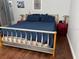 Bedroom featuring a bed with blue bedding and wood laminate flooring at 9721 Old Patina Way, Orlando, FL 32832