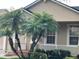 Beautiful home with mature palm trees, a manicured lawn, and a cozy front porch with white railings at 9721 Old Patina Way, Orlando, FL 32832