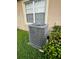 Outdoor AC unit with lush green grass and landscaping at 9721 Old Patina Way, Orlando, FL 32832