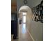 Welcoming hallway featuring neutral tones and arched doorway at 9721 Old Patina Way, Orlando, FL 32832