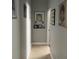 Hallway with tile floors, gray walls, and framed artwork at 9721 Old Patina Way, Orlando, FL 32832
